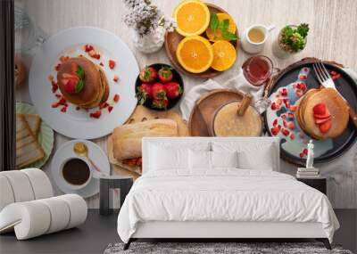 Breakfast table full of food brunch pancakes, bread and fruit Wall mural