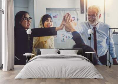 Group of diversity business people stacking hands for teamwork concept, at meeting room in office Wall mural