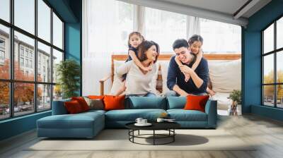 Happy Asian family playing together at sofa, home living room Wall mural