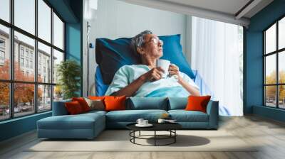 Lonely old asian patient on patient bed in hospital Wall mural