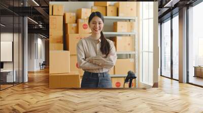 Portrait confidence Asian woman entrepreneur working at online store warehouse over parcel boxes on shelves, online e-commerce retail small business concept Wall mural