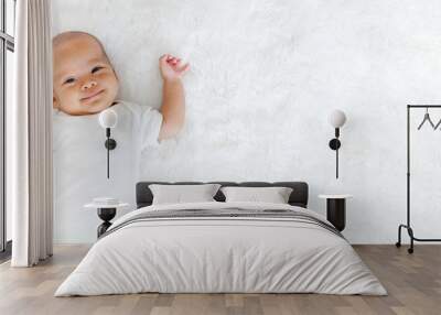 Portrait newborn baby happy over white background, topview Wall mural