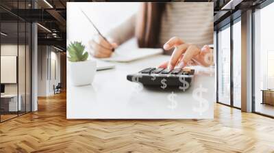 Woman accountant working with computer and calculator for business and financial expense Wall mural