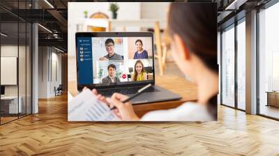 Young Asian businesswoman work at home and virtual video conference meeting with colleagues business people, online working, video call due to social distancing Wall mural