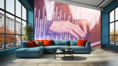 Businessman using the laptop working with Stock market chart graphic, Business trading and technology concept. Wall mural