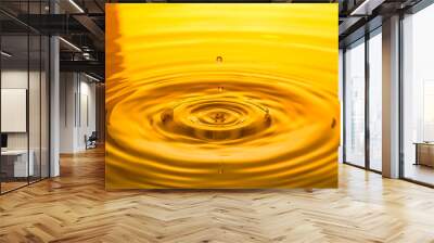 close up of a drop oil on a yellow background Wall mural