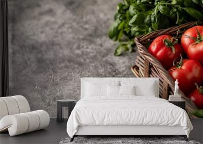 Basket on kitchen counter filled with fresh tomatoes, peppers, and greenery. Ideal for culinary arts and healthy eating visuals. Wall mural