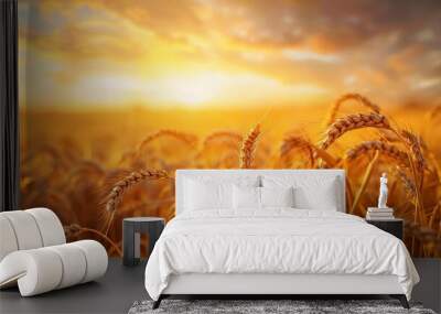 Golden wheat field at sunset representing agriculture and natural resources Wall mural