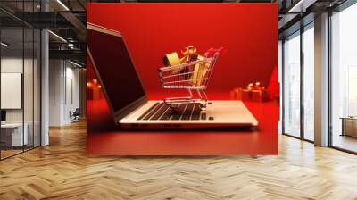 Christmas gifts in the shopping cart with laptop for shopping online on red background, Christmas festival Wall mural