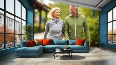 Middle aged love couple walking outside in a park, healthy, lifestyle Wall mural