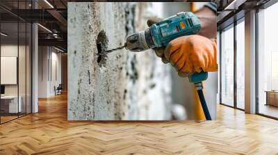 Closeup of a hand drilling a hole in a wall  Wall mural