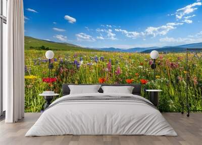 A vibrant field of wildflowers with an array of colors under a clear blue sky, creating an idyllic scene Wall mural