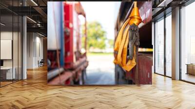 Close-up at locking device of safety latching strap that using for secure equipment or heavy object that transport on trailer truck. Transportation industrial equipment object, selective focus. Wall mural