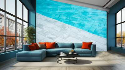 Luxury swimming pool which is built from white marble rock material, full filled with clearly blue water. Background and object photo. Wall mural