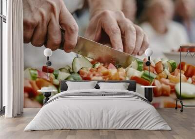 A chef skillfully chops fresh vegetables on a wooden cutting board, showcasing culinary techniques in a lively cooking environment. Wall mural