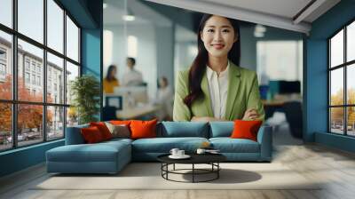 happy asian confident positive female entrepreneur standing in office arms crossed Wall mural