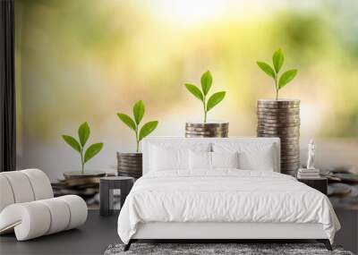 Showing financial developments and business growth with a growing tree on a coin with blurred nature background, and financial concepts, copy space, business, investment, finance, a pile of coins Wall mural