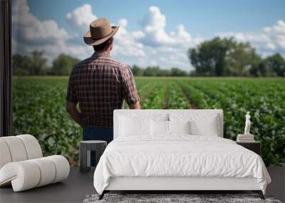 Farmer Surveying Lush Green Agricultural Farmland Wall mural