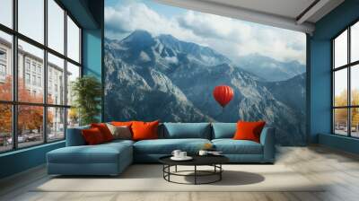 A single balloon drifting against a backdrop of a majestic mountain range, showcasing the beauty of nature. Wall mural