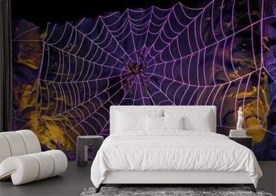 Detailed spider web silhouette with haunting purple and yellow lighting on a black wall, Halloween night. Wall mural