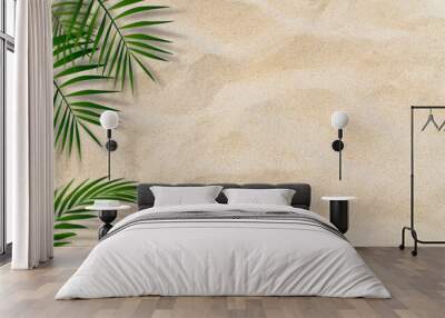 Palm leaves over sand beach top view well free space for text present summertime season background  Wall mural