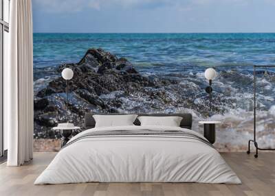 rocks and wave on the beach Wall mural