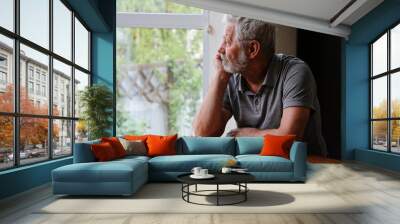 Senior retired man sitting at home alone while quarantine Wall mural