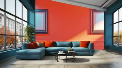 A chic living room with a coral wall, featuring two empty frames in a diagonal arrangement, each under a bright spotlight. Wall mural