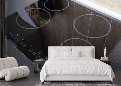 Close up view of an electrical kitchen induction ceramic hob with kitchen furniture Wall mural