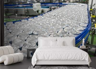 Conveyor line carrying thousands aluminum beverage cans at factory. Concept of industrial growth Wall mural