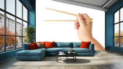 Hand holding disposable wooden chopsticks made of bamboo isolated on white background Wall mural