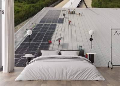 Solar panels installed on a roof of a large industrial building or a warehouse. Industrial buildings in the background. Horizontal photo. Wall mural