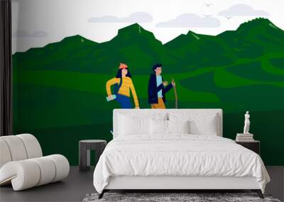 A couple is hiking in the mountains with a beautiful background Wall mural