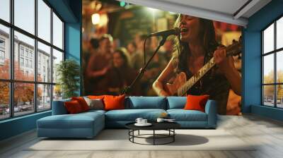 A young woman is singing and playing guitar in a pub with a crowd of people in the background. The woman wearing a dress, The pub crowded, The woman in the foreground with the pub in the background, Wall mural