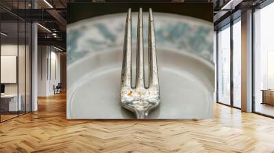 Fork resting on a plate, ready for a meal Wall mural