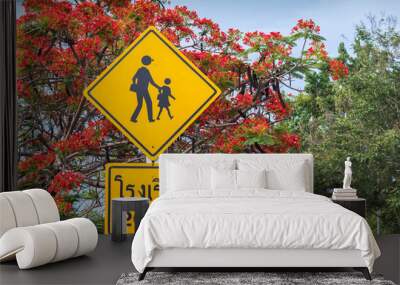 A sign showing the mann and children on the road (Thai word is mean school 200 m.) Wall mural