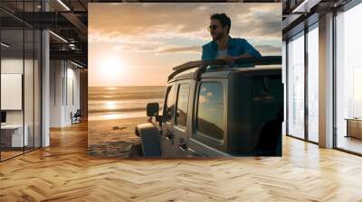 man on top of a jeep in the beach  Wall mural