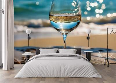 wine glass on the sand of a beach Wall mural