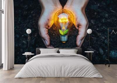 Glowing Light Bulb Plant Growing in Soil Held by Hands Wall mural