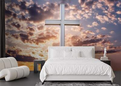 white shining christian cross on the orange cloudy sky background Wall mural