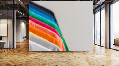 Close up of Colorful t-shirts on hangers, apparel background Wall mural