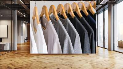 Close up of T-shirts on hangers, apparel background Wall mural