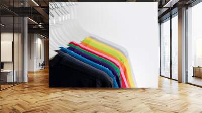 Colorful t-shirts hanging on a rack Wall mural