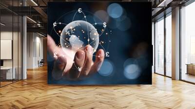 A hologram of a globe in hands of a businessman. And there are virtual lines of currency flows such as yen, yuan, dollars, pounds, euros, revolving around the world. global currency exchange concept Wall mural