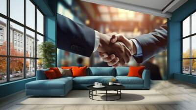 Two successful businessmen shake hands in celebration of merger and acquisition - symbolizing teamwork, negotiation, and partnership

 Wall mural