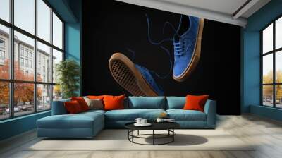 Close up view of levitation blue sneakers shoes with  flying laces over black background with copy space for text.  Wall mural