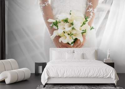 Bride holding beautiful white wedding flowers bouquet Wall mural