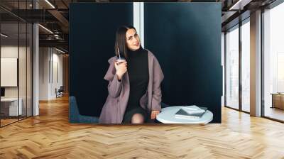 Portrait of beautiful smiling woman sitting in a cafe Wall mural