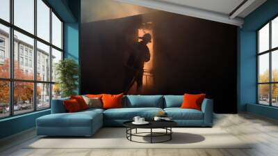 Silhouette of fireman fighting bushfire at night Wall mural