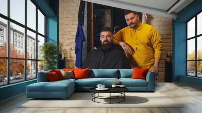 Client with big black beard during beard shaving in barber shop Wall mural